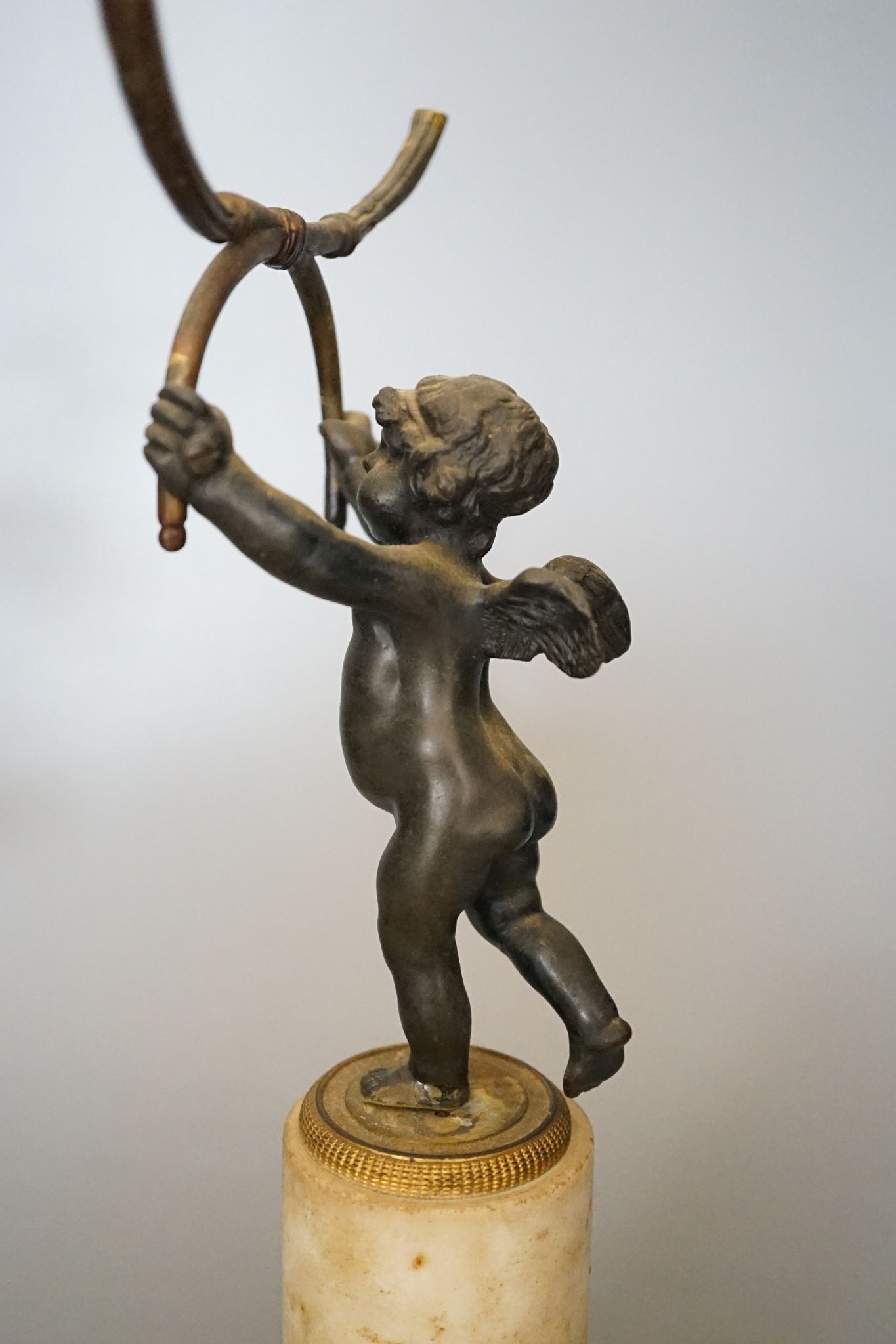 A pair of 19th century bronze and ormolu cherub candelabra, on alabaster plinths, 33cm